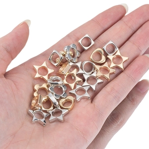 Assorted gold and silver geometric plastic CCB beads for DIY jewelry making held in hand