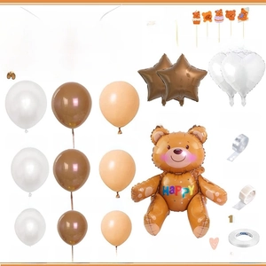 Flat lay of vintage bear party set with balloons, cake toppers, and birthday banner