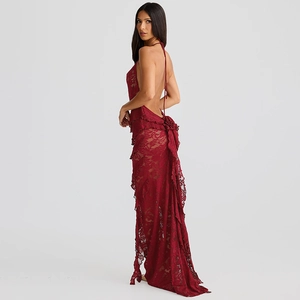 Detail of red lace evening gown featuring an open back design and ruffled lace hem