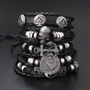 Detailed shot of multi-layer black leather bracelets with skull and anchor charms
