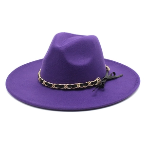 Detail of purple wool fedora featuring a gold chain and black leather decorative band