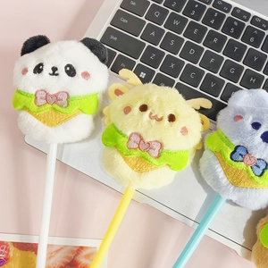 Cute panda, deer, and bear plush animal ballpoint pens on a laptop keyboard