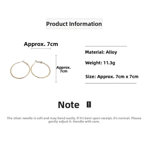 Detailed view of large gold hoop earrings with 7cm diameter and silver needles