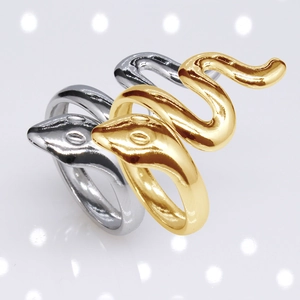 Close-up of polished snake-shaped rings in gold and silver finish with detailed texture