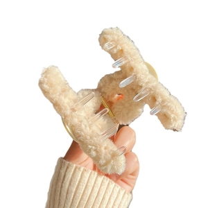 Elegant beige plush hair claw clip with smiley face and transparent grip for women