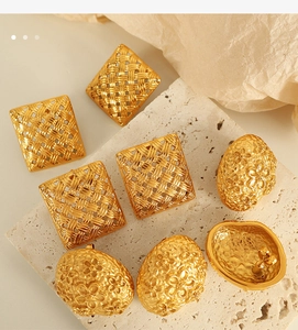 Macro detail of 18k gold plated earrings featuring woven textures and floral relief