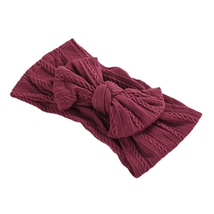 Burgundy knit baby headband with large bow and vintage cable pattern for girls