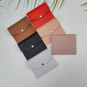 Multiple ultra-thin card holders in various colors with textured faux leather and snap button