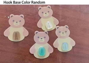 Detail of four adhesive bear mounts with random colored buckles for toothbrush holder