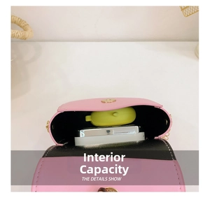 Detail view of pink girl's crossbody bag showing internal storage for a phone and small items
