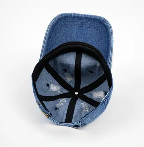 Detail view of the blue distressed denim baseball cap showing internal structure and sweatband