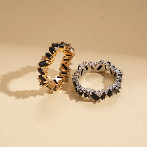Irregular geometric rings with black zircon in gold and silver metal finishes