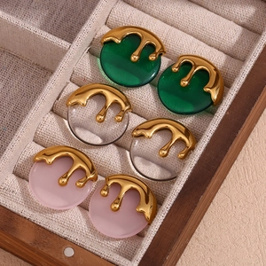 Detailed macro view of vintage round earrings in gold finish with resin texture