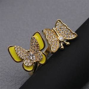 Macro shot of gold-plated butterfly ring with yellow enamel and micro-pave cubic zirconia