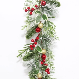 Artificial Christmas garland with pine needles, red berries, and festive ornaments on white