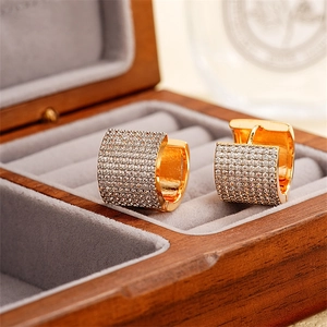 Elegant gold U-shaped heart earrings with pavé crystals in a wooden jewelry gift box