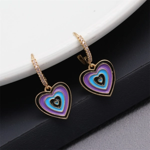 Detail showing colorful enamel layered heart earrings with gold plating and zircon inlay