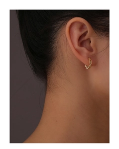 Detail of 14k gold plated S925 silver hollow heart hoop earring on female model