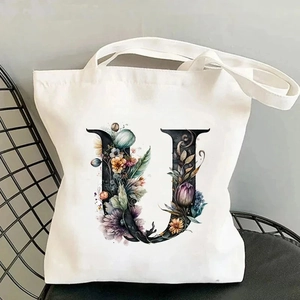 Detail of canvas tote bag featuring floral alphabet U print in high quality artistic style