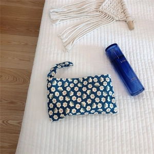 Close-up of floral cotton mini pouch with blue flower patterns and carry strap