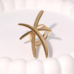 Minimalist gold dragonfly ring with polished streamlined design on wave display