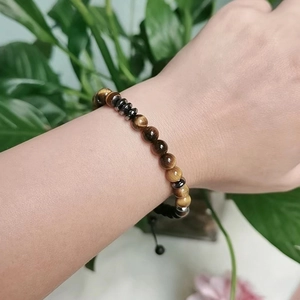 Tiger Eye beaded Morse Code bracelet for Mother and Daughter shown on wrist with plants
