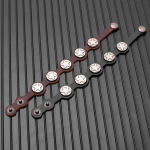 Detailed view of vintage leather bracelets with star rivets in black and brown colors