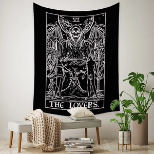 Macro detail of Bohemian tarot lovers tapestry with skull design hanging on a minimalist wall