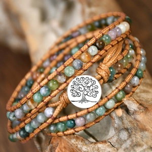 Macro shot of multi-layer natural agate stone beaded leather bracelet with tree of life button