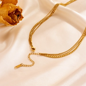 Three-layer celestial necklace with moon and star pendants on elegant silk background
