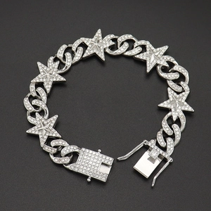 Detailed macro view of silver iced-out Cuban chain bracelet with rhinestone star charms