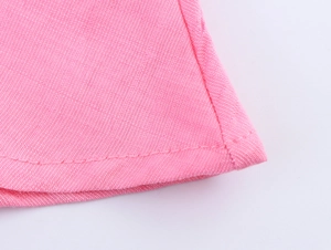 Close-up of pink dress fabric texture showing neat stitching and fine woven material