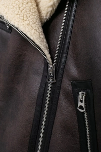 Macro detail of high-quality silver metal zipper and thick lamb wool lining on jacket