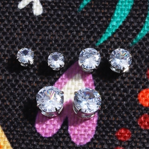 Classic silver-plated four-prong round cubic zirconia stud earrings in assorted sizes
