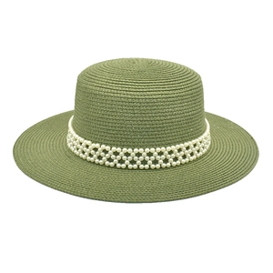 Detail of sage green straw hat featuring an intricate white pearl woven decorative band