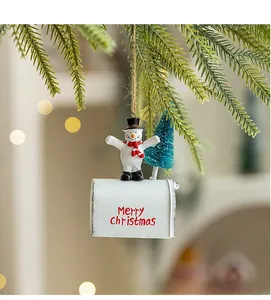 Close-up of a festive Christmas mailbox ornament with a snowman and mini pine tree details