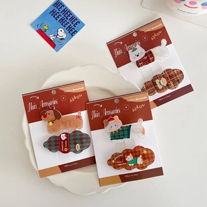 Cartoon cat and dog hair clips with Christmas theme on elegant white ceramic plate