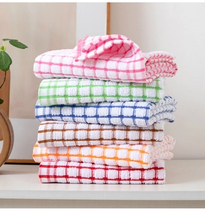 Close-up of stacked colorful checkered cotton tea towels with absorbent woven texture