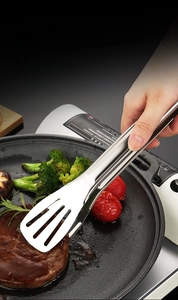Close-up of stainless steel food tongs with three-hole slotted head for draining oil easily