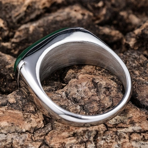 Vintage stainless steel ring featuring a green cat-eye gemstone and brushed metal texture
