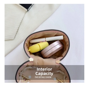 Detailed interior view of pink quilted handbag showing capacity for lipstick and powder