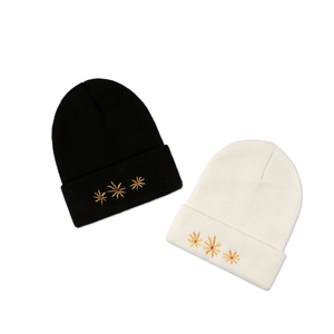 Knit beanie hat for women with golden flower embroidery in black and white colors