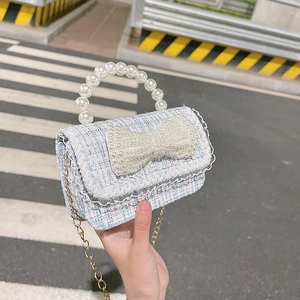 Mini tweed handbag for girls with pearl bow and beaded handle in light blue finish