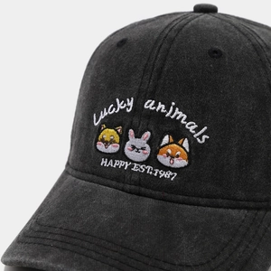 Close-up of cute animal embroidery on washed charcoal grey cotton baseball cap detail
