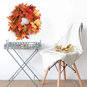 Autumn maple leaf garland with orange foliage and berries for Halloween decoration