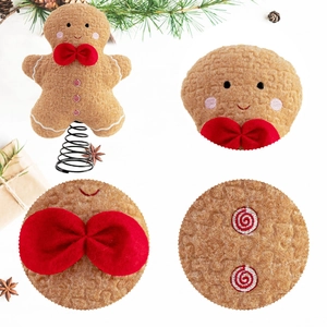 Lebkuchenmann-Federanhänger als Christbaumspitze mit roter Schleife und weißen Stickereien