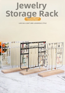 Three-tier metal jewelry organizers in black white and silver with wooden bases