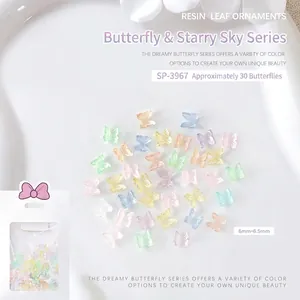 Macro view of iridescent resin butterfly nail charms with shimmering aurora starry finish