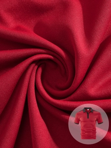 Detailed close-up of red breathable pique cotton fabric on a men's polo shirt