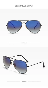 Detail of aviator sunglasses with black metal frame and blue gradient lenses